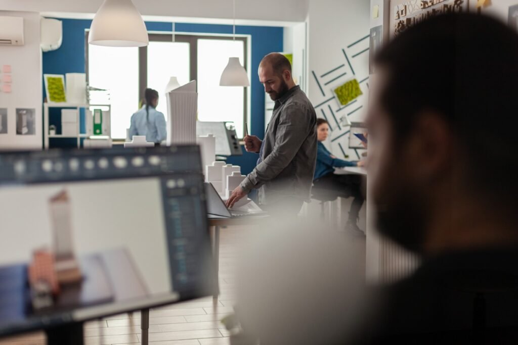 engineer looking at blueprints on laptop at desk w 2025 02 19 21 17 49 utc.jpg
