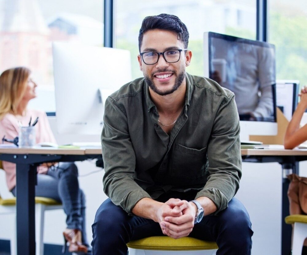 Portrait Of A Young Businessman Sitting In An Offi 2025 04 06 07 38 43 Utc E1749106625517